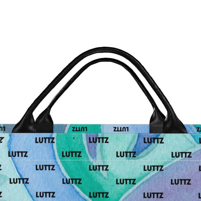 Colorful luxury bag by LUTTZ, featuring Mediterranean design and leather handles, embodying an exclusive artistic style.