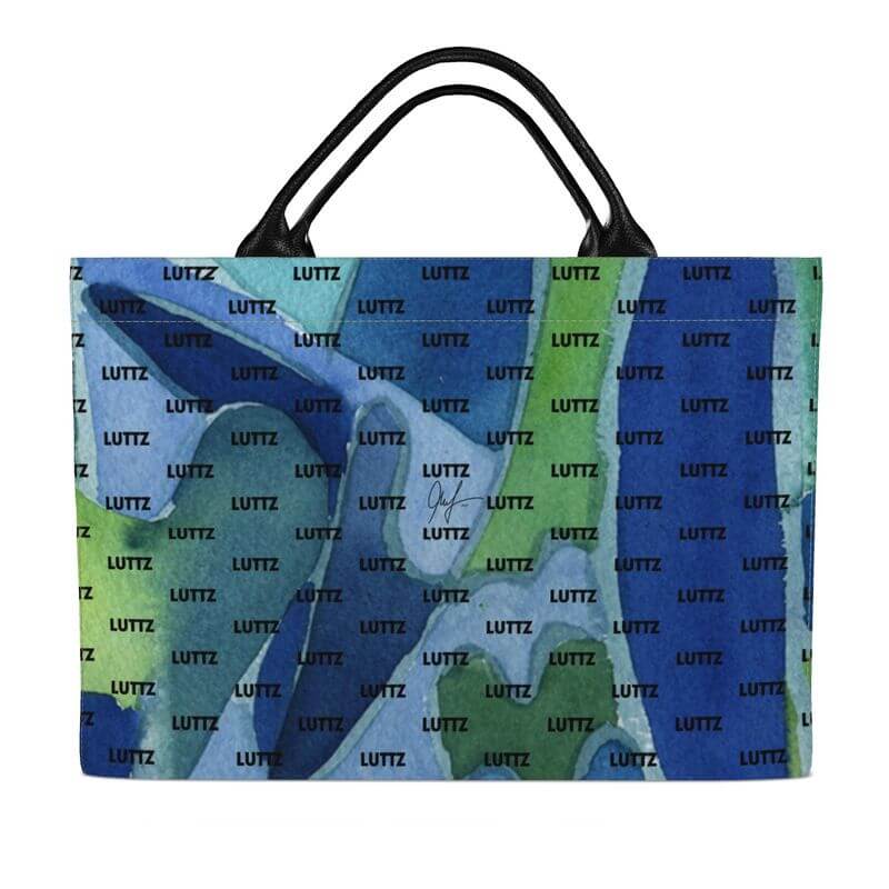 Colorful luxury DEEP WATER bag by LUTTZ, featuring unique Mediterranean fabric design and leather handles, inspired by South of France.