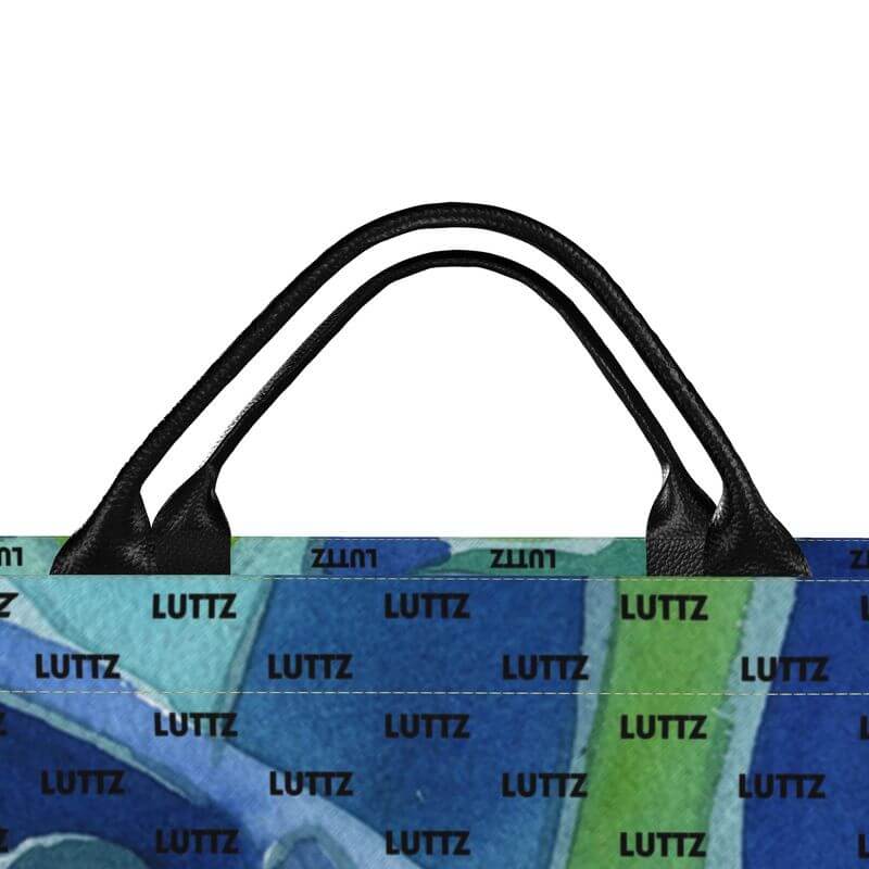 Colorful designer bag handle from LUTTZ, featuring Mediterranean-inspired artwork in vibrant blues and greens.