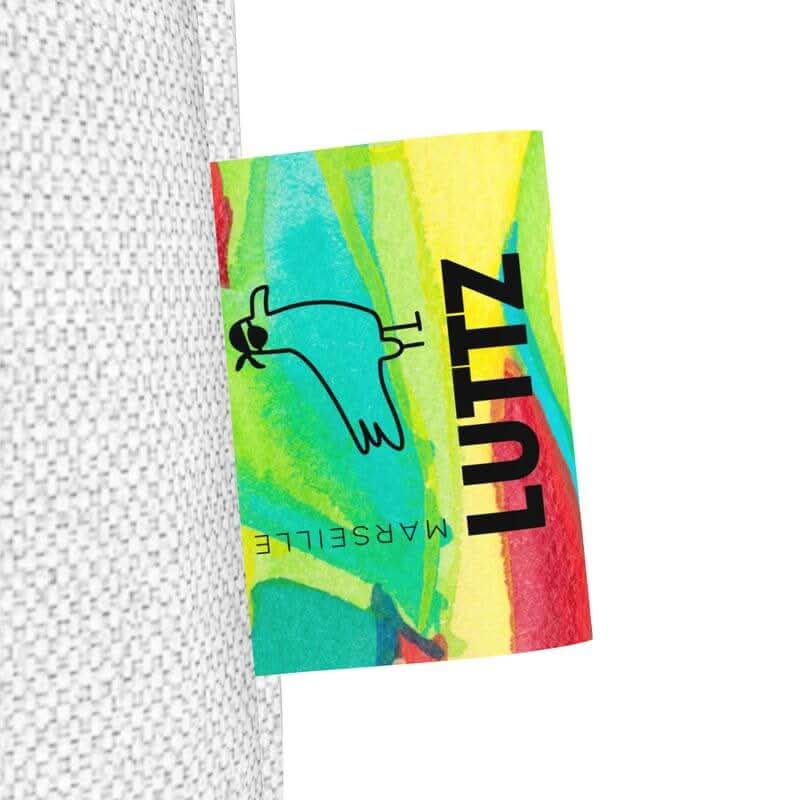 Close-up of the colorful LUTTZ tag on the UNIQUA tote bag, showcasing its vibrant and unique design.