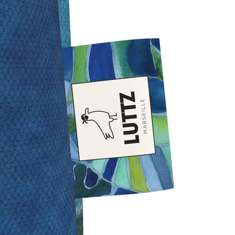 LUTTZ Marseille logo tag on a green-blue tote bag, showcasing unique Mediterranean fabric design.