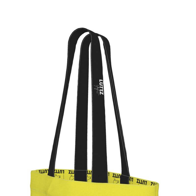 Yellow Lutz tote bag featuring unique black straps, a luxury minimalist design inspired by Mediterranean style.