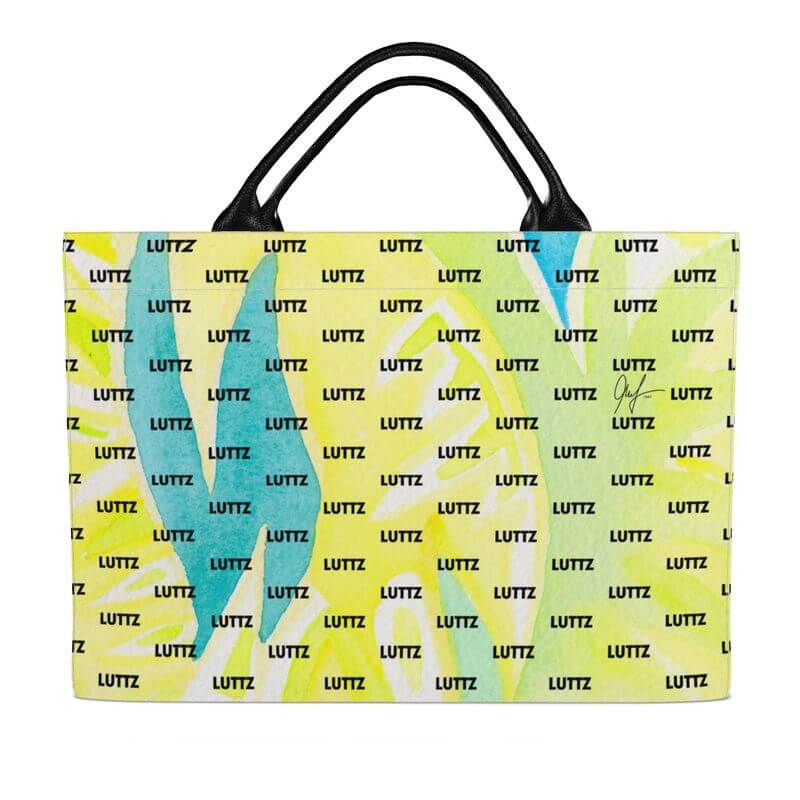 Luxury LUTTZ bag in unique Mediterranean fabric design, bright yellow and green, perfect for beach outings.