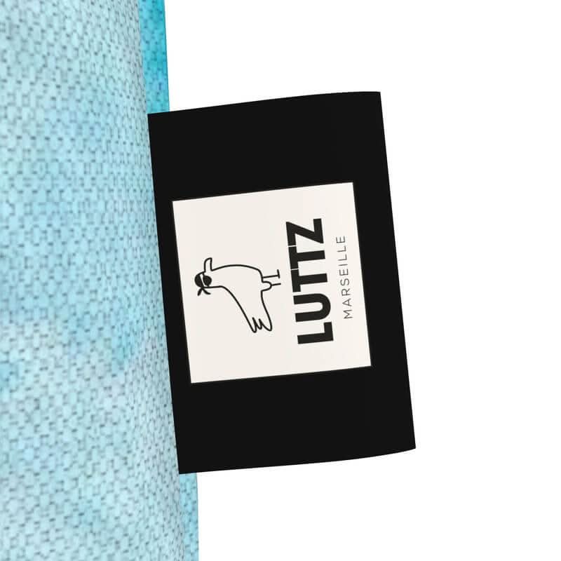 LUTTZ brand label on a blue tote bag, showcasing unique design and 100% cotton denim texture.