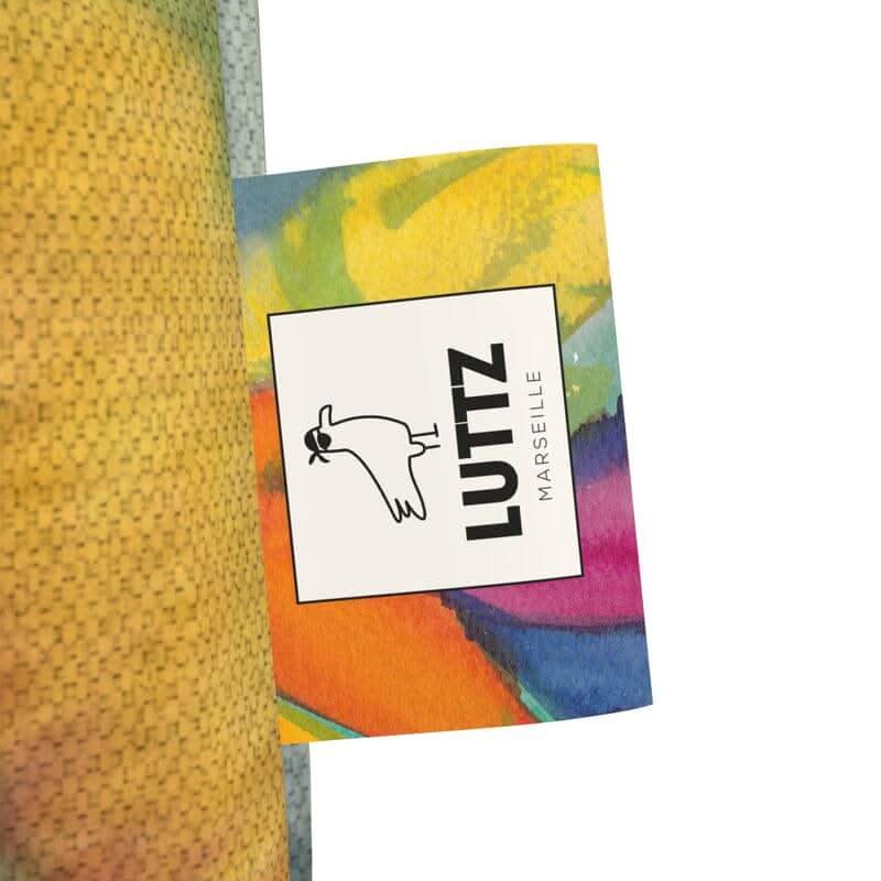 LUTTZ Marseille label on a tote bag featuring exceptional Mediterranean fabric design and vibrant, abstract artwork.