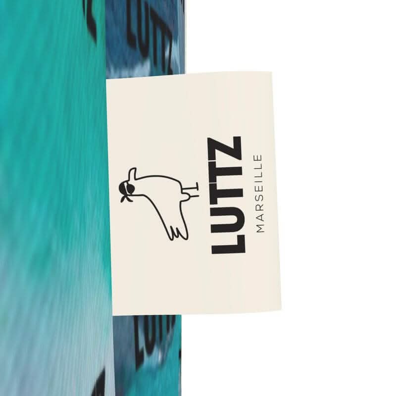 LUTTZ Marseille logo on a vibrant Mediterranean fabric, showcasing a unique designer piece.