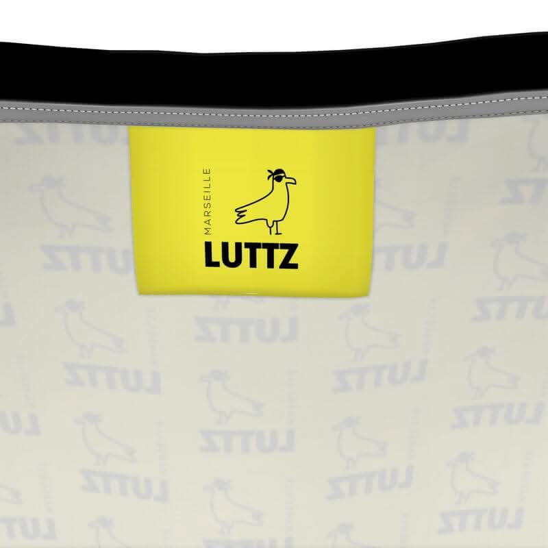 LUTTZ brand tag featuring Marseille logo on luxury fabric, showcasing unique minimalistic design and Mediterranean inspiration.