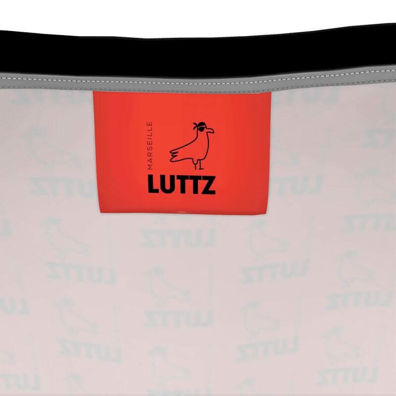 Close-up of LUTTZ tag from Marseille, showcasing the brand's unique and elegant design, reflecting Mediterranean inspiration.