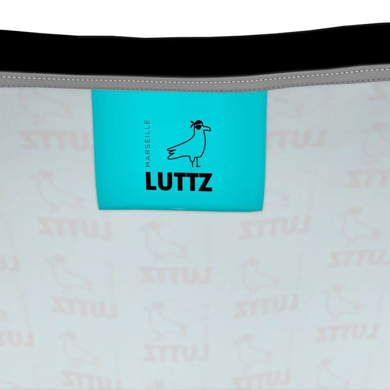 Inside label of LUTTZ bag showcasing unique fabric design and brand name, inspired by Mediterranean elegance.