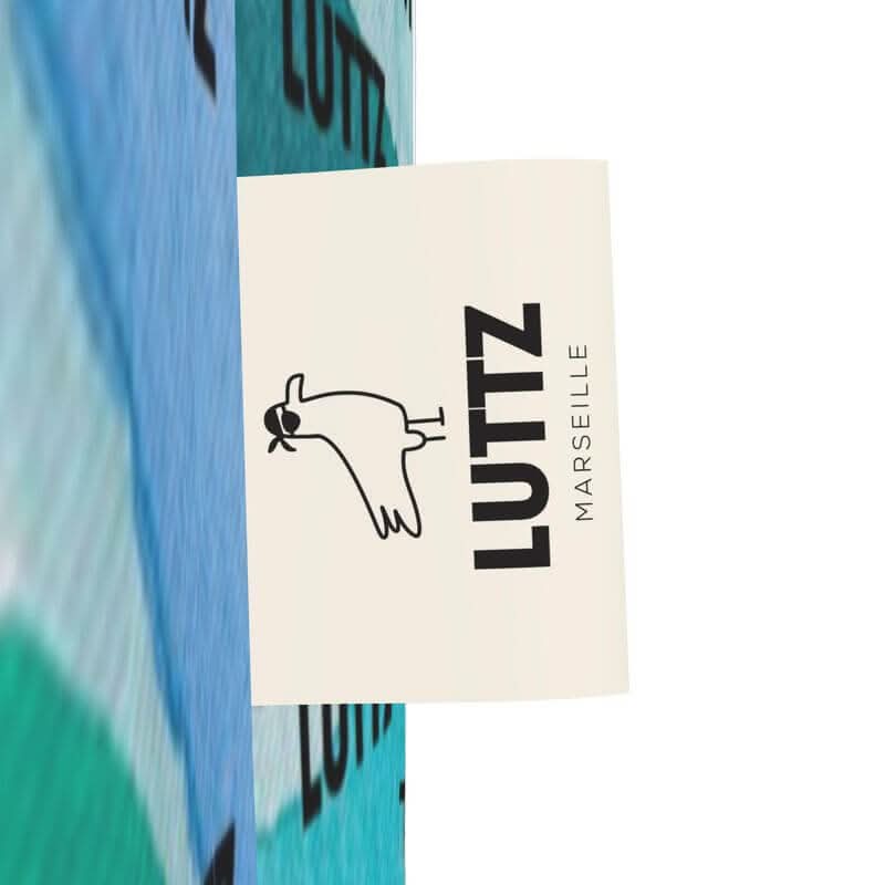 Close-up of LUTTZ brand logo showcasing unique Mediterranean fabric design from Marseille.