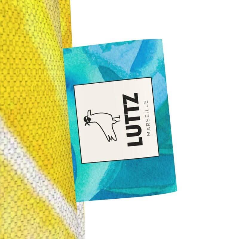 LUTTZ Marseille brand tag showcasing the unique design of the luxury tote bag inspired by Mediterranean aesthetics.