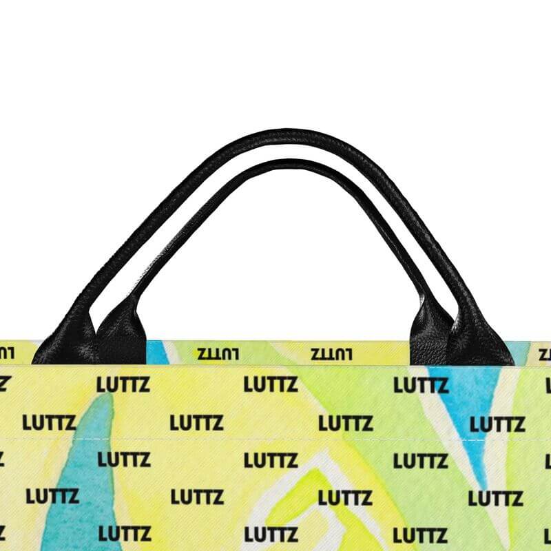 Unique LEMON WATER bag by LUTTZ, featuring a colorful abstract design and leather handles, perfect for the beach.