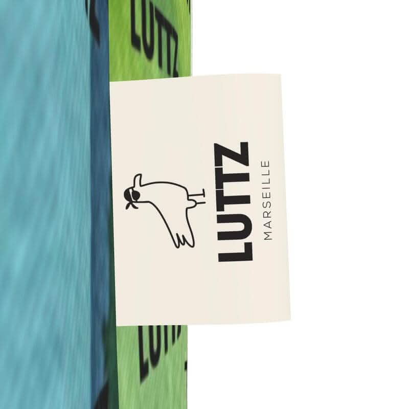 LUTTZ label showcasing unique Mediterranean fabric design from Marseille, featuring colorful artwork and joyful aesthetics.