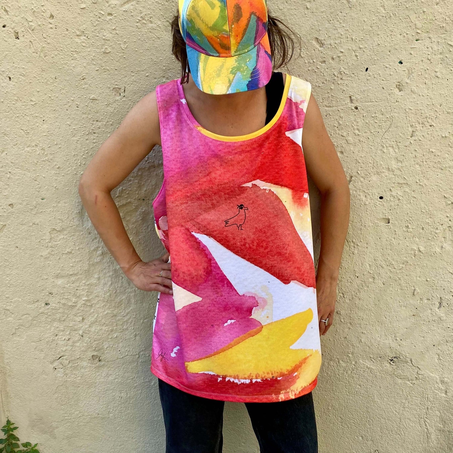 young woman on the street wears designer tank top by LUTTZ with LUTTZ branding on colorful fabric pattern and minimalistic art design. 