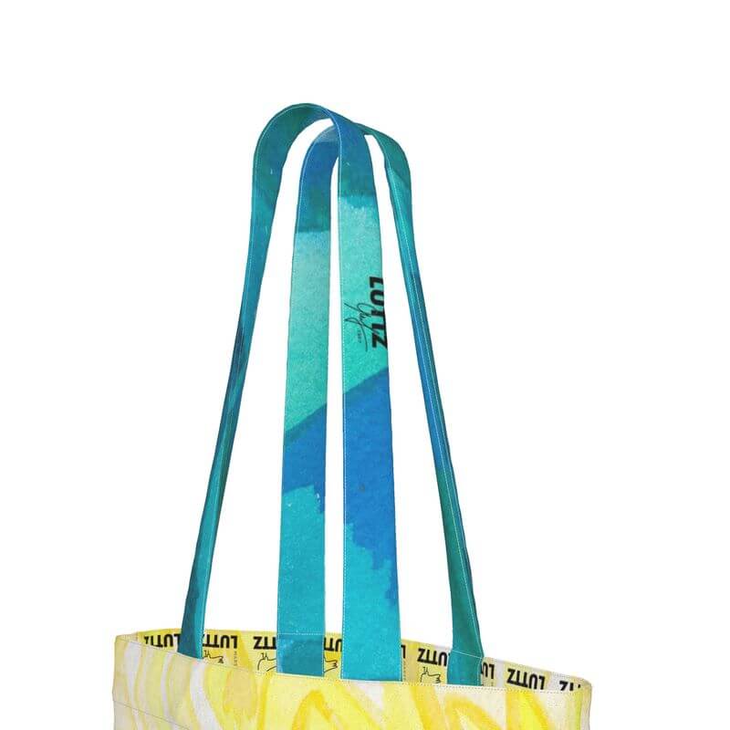 Close-up of the unique designer straps of the LEMON tote bag, showcasing its Mediterranean-inspired colors and artwork.