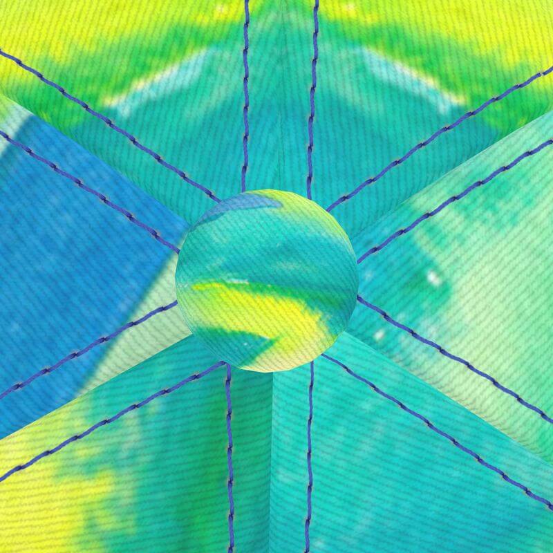 Detailed view of a unique baseball cap featuring vibrant Mediterranean fabric design in blue and green hues, handcrafted.
